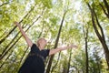 Young woman in green forest