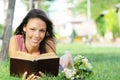 Young woman in green park, book and reading Royalty Free Stock Photo