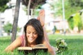 Young woman in green park, book and reading Royalty Free Stock Photo