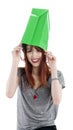 Young Woman with Green Shopping Bag on Head Royalty Free Stock Photo