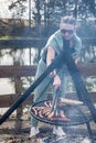 A young woman grills sausages on the grill