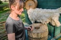 Young woman grinds flour by hand mills. Retro millstone for grinding grain and corn