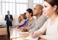 Young woman with group of adult people during professional training Royalty Free Stock Photo