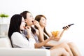 young woman group eating snacks and watching the tv Royalty Free Stock Photo