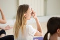 Young woman and group of people doing Alternate Nostril Breathin Royalty Free Stock Photo