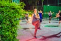 Young woman on a group workout on the basketball court in the evening