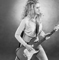 Young woman with a guitar performing a rock song. black and white photo