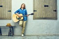 Young woman guitar playing on street. Royalty Free Stock Photo