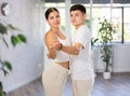 Young woman and young guy dancing pair dance