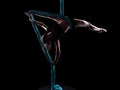 Young woman gymnast with blue gymnastic aerial silks