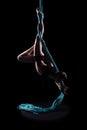 Young woman gymnast with blue gymnastic aerial silks