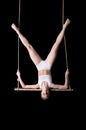 Young woman gymnast on a trapeze