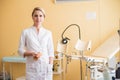 Young woman gynecologist standing behind an armchair