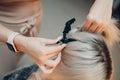 Young woman hairdresser with pin dying hair at beauty salon. Professional hair roots coloring Royalty Free Stock Photo