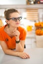 Young woman in Halloween decorated kitchen looking aside Royalty Free Stock Photo