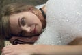 Young woman having soap foam massage in hammam or turkish bath.