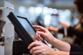 Young woman hand doing process payment on a touchscreen cash register, POS, finance concept