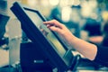 Young woman hand doing process payment on a touchscreen cash register, POS, finance concept