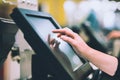 Young woman hand doing process payment on a touchscreen cash register, POS, finance concept