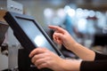 Young woman hand doing process payment on a touchscreen cash register, POS, finance concept