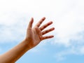 Young woman hand. Empty hand reach out or hold over blue sky. Help and hope hand concept Royalty Free Stock Photo