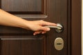 Young woman hand hold wooden door handle Royalty Free Stock Photo