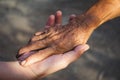 Young woman hand holding elderly person`s hand Royalty Free Stock Photo