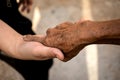 Young woman hand holding elderly person`s hand Royalty Free Stock Photo