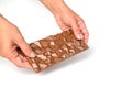 Young woman hand holding milk chocolate bar isolated on white. Chocolate in female hands. Sweet snack. Closeup. Royalty Free Stock Photo