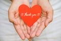 Young woman hand holding red heart paper with THANK YOU message. Royalty Free Stock Photo