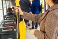 Young woman hand inserts the bus ticket into the validator, validating and ticking in Prague sity Chezh Royalty Free Stock Photo