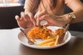 in young woman hand select focus, Hand with fried chicken blur background, Close-up Fried chicken Royalty Free Stock Photo
