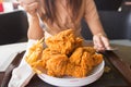 in young woman hand select focus, Hand with fried chicken blur background, Close-up Fried chicken Royalty Free Stock Photo