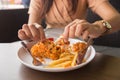 in young woman hand select focus, Hand with fried chicken blur background, Close-up Fried chicken Royalty Free Stock Photo