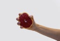 Young woman hand squeezing fresh halved red grapefruit Royalty Free Stock Photo