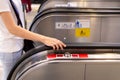 Young woman hand touching escalator handrail while using the escalator Royalty Free Stock Photo