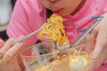 Young woman hand using chopstick blow hot and eating noodles Royalty Free Stock Photo