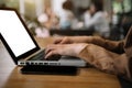 Young woman hand working on his laptop with blank space screen for your advertising text in office back view of busy businessman