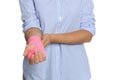 Young woman with hand wrapped in medical bandage on white background, closeup