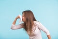 Young woman with handkerchief. Sick girl isolated has runny nose on blue background Royalty Free Stock Photo