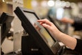 Young woman hands counting, entering discount, sale to a touchscreen cash register, POS, finance concept