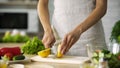 Young woman hands cutting yellow lemon on kitchen board at home, healthy eating Royalty Free Stock Photo