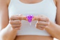 Young woman hands folding a menstrual cup.