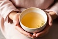 Young woman hands holding aromatic teacup cup of green leaves tea hot steaming beverage morning comfy comfortable Royalty Free Stock Photo