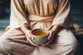 Young woman hands holding aromatic teacup cup of green leaves tea hot steaming beverage morning comfy comfortable Royalty Free Stock Photo