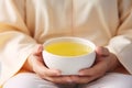 Young woman hands holding aromatic teacup cup of green leaves tea hot steaming beverage morning comfy comfortable Royalty Free Stock Photo