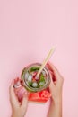 Young woman hands holding freshly squeezed watermelon lemonade of citrus fruits. Female with mason jar full of cold cocktail, mint Royalty Free Stock Photo