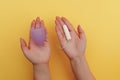 Young woman hands holding menstrual cup and tampon. Concept of women& x27;s hygiene