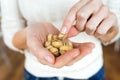 Young woman hands holding and picking up a pistachios nuts at home Royalty Free Stock Photo