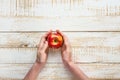 Young Woman Hands Holding Ripe Red Apple on White Plank Wood Background Tabletop.Flat Lay Top View Thanksgiving Harvest Autumn Royalty Free Stock Photo